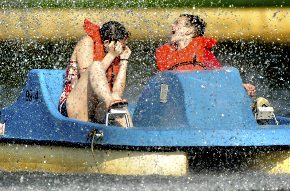 soaked boaters riding through the fountain spray